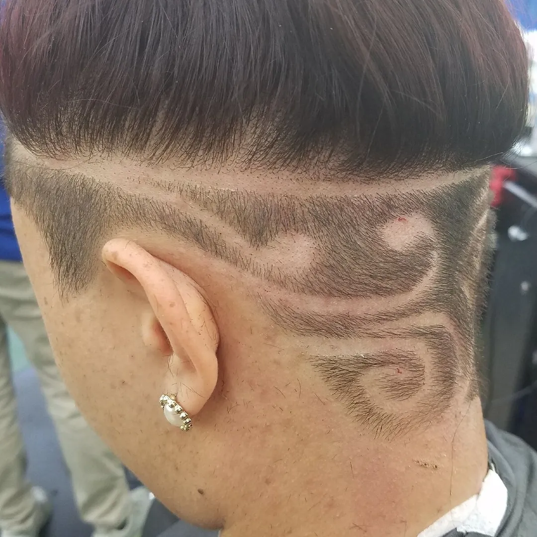 Freehand curved line design on the side of a fade