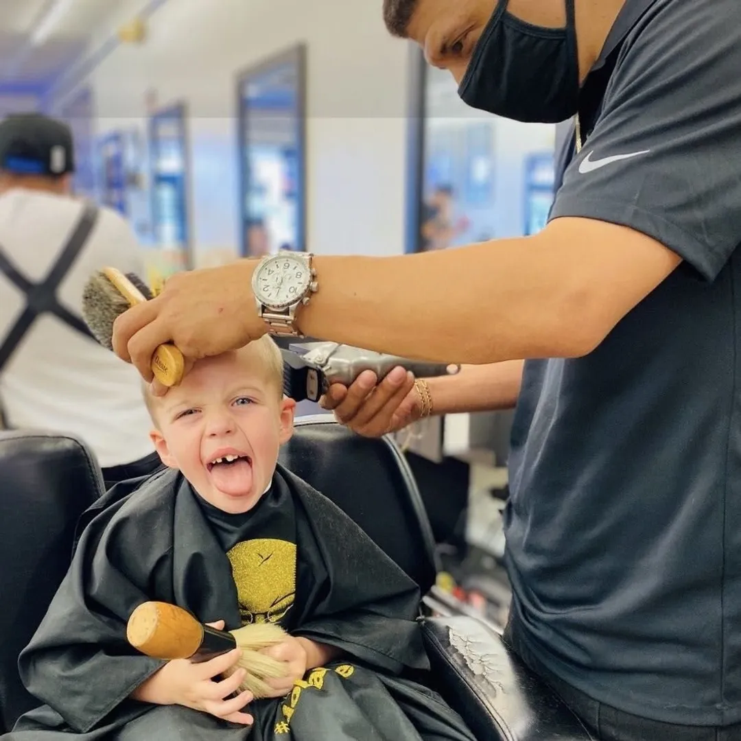 A young client getting a fresh cut in the chair